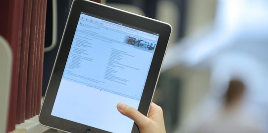 Tablet University Library Photo of a tablet with the TU University Library home page open.